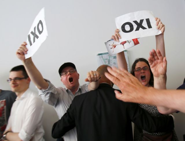 Ελληνες διέκοψαν ομιλία της Μέρκελ στο Βερολίνο με πλακάτ υπέρ του «όχι»
