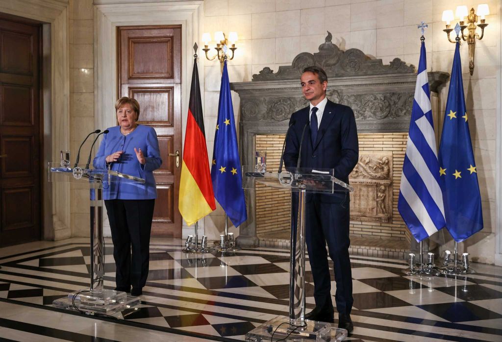 Merkel says she ‘demanded much of the Greeks’ but it was necessary to protect the common currency